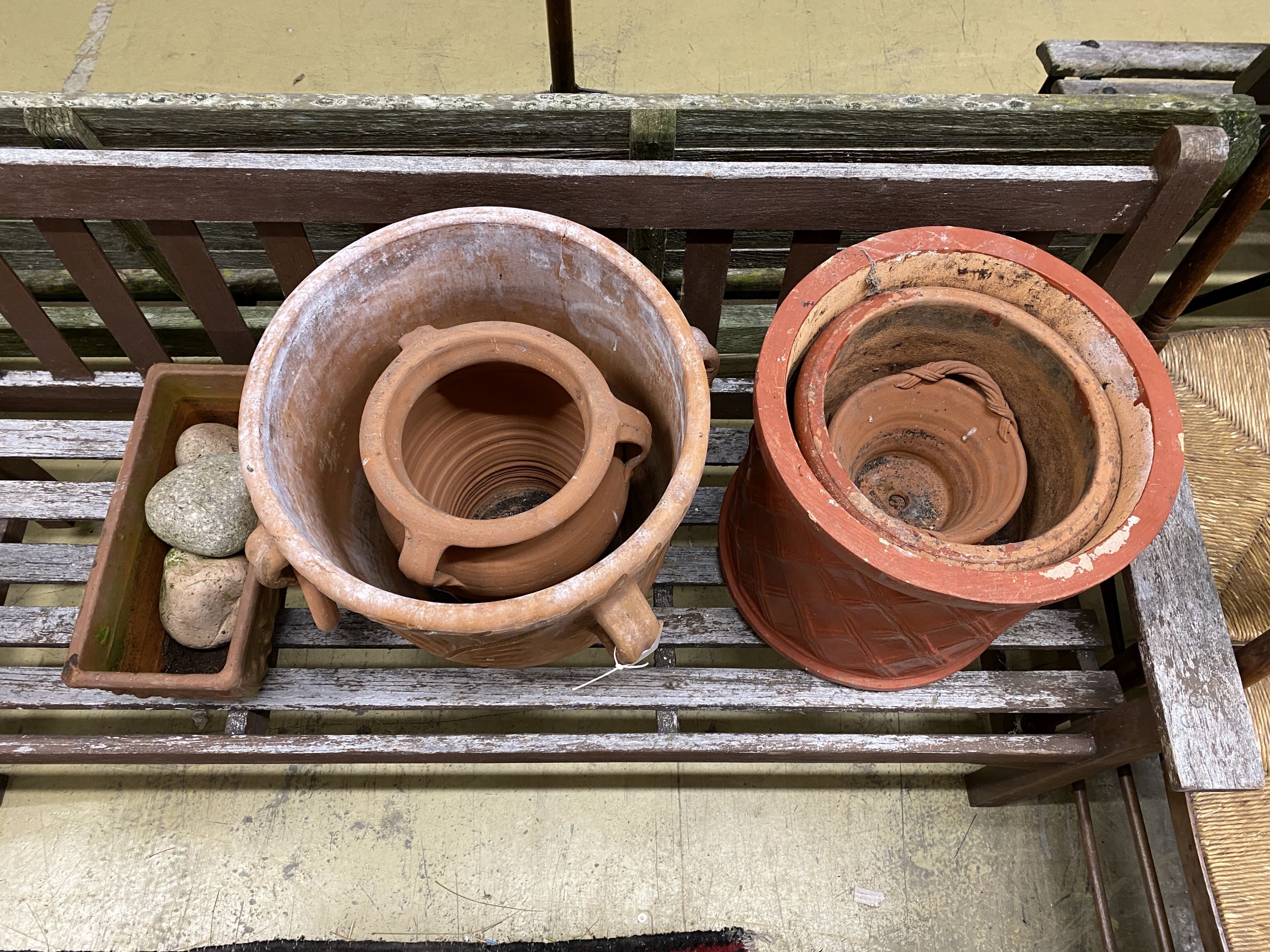 Six terracotta garden planters and three pebble ornaments, largest diameter 40cm, height 40cm